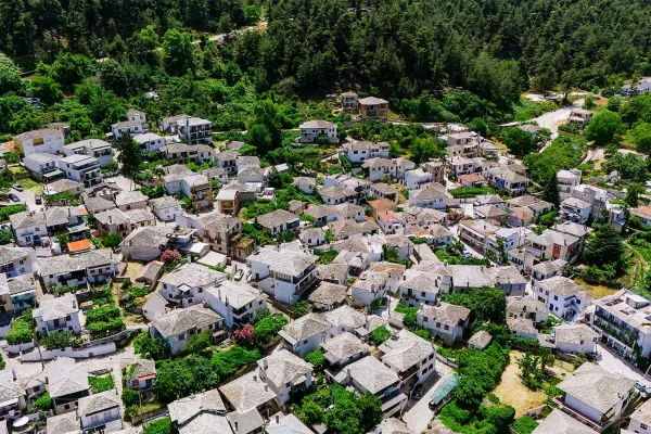 whitewashed-traditional-houses-with-stone-roofs-surrounded-by-lush-greenery3EF36129-28DF-AAD5-0203-7E09B9023B28.webp