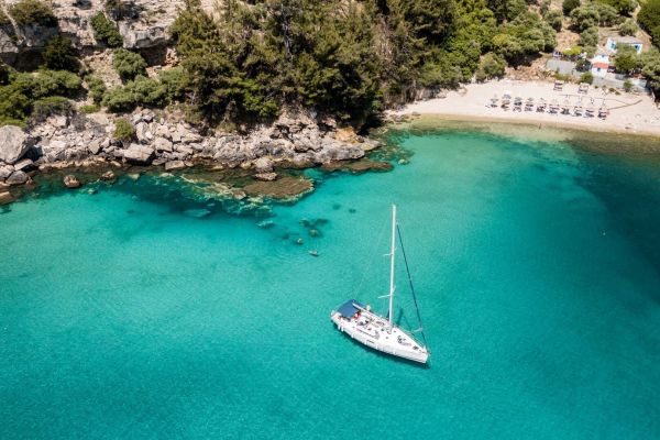 aerial-view-of-a-northsailing-sailboat-anchored-in-a-secluded-turquoise-bay-during-a-sailing-cruise-near-thassos85306A49-C581-C097-34D4-62D5A321D540.jpg